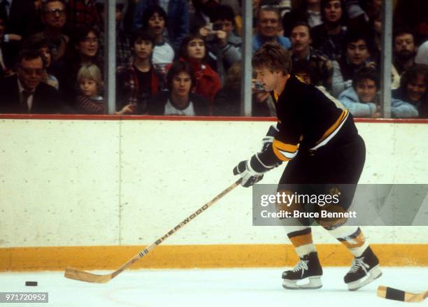 Bobby Orr of the Boston Bruins Alumni team skates with the puck during an Alumni game circa February, 1983 at the Boston Garden in Boston,...