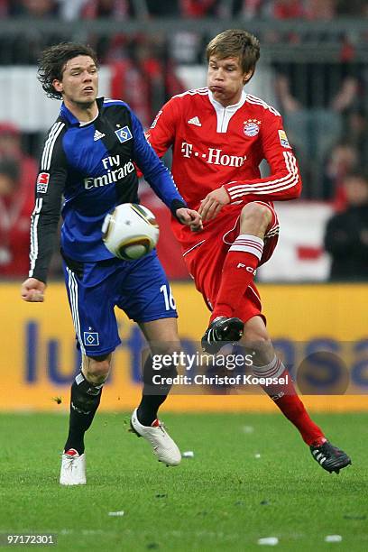 Holger Badstuber of Bayern and Marcus Berg of Hamburg battle for the ball during the Bundesliga match between FC Bayern Muenchen and Hamburger SV at...