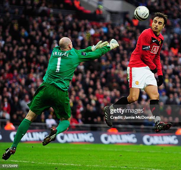 Dimitar Berbatov of Manchester United is challenged by goalkeeper Brad Friedel of Aston Villa during the Carling Cup Final between Aston Villa and...