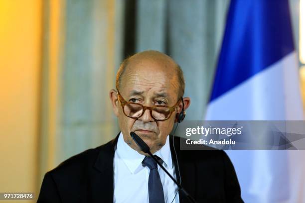 French Foreign Minister Jean-Yves Le Drian listens during a joint press conference following a Normandy format meeting with German Foreign Minister...