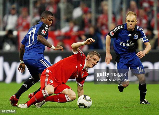 Bastian Schweinsteiger of Bayern is defended by Eljero Elia and David Jarolim of Hamburg during the Bundesliga match between FC Bayern Muenchen and...
