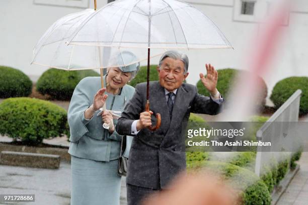 Emperor Akihito and Empress Michiko wave to well-wishers on arrival at the Odaka lifelong learning center on June 10, 2018 in Minamisoma, Fukushima,...
