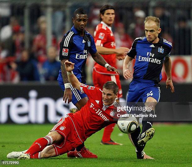 Bastian Schweinsteiger of Bayern is defended by Eljero Elia and David Jarolim of Hamburg during the Bundesliga match between FC Bayern Muenchen and...