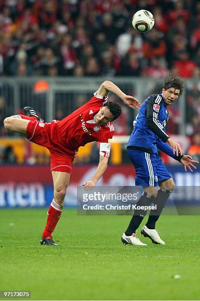 Mark van Bommel of Bayern and Marcus Berg of Hamburg jump for a header during the Bundesliga match between FC Bayern Muenchen and Hamburger SV at...