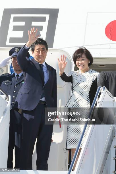 Japanese Prime Minister Shinzo Abe and his wife Akie wave on departure for Japan at Quebec City Airport on June 10, 2018 in Quebec City, Canada. Abe...