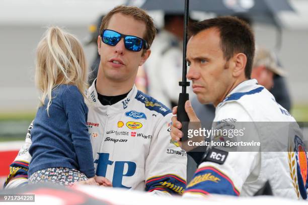 Brad Keselowski , driver of the Miller Lite Ford, is seen holding his daughter prior to the start of the Monster Energy NASCAR Cup Series -...