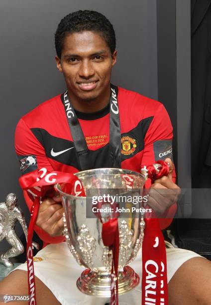 Antonio Valencia of Manchester United poses with the Carling Cup trophy in the dressing room after the Carling Cup Final match between Aston Villa...