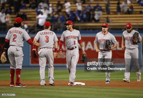 Alex Blandino, Scooter Gennett, Billy Hamilton, Adam Duvall and Jose Peraza of the Cincinnati Reds line up to celebrate after their MLB game against...