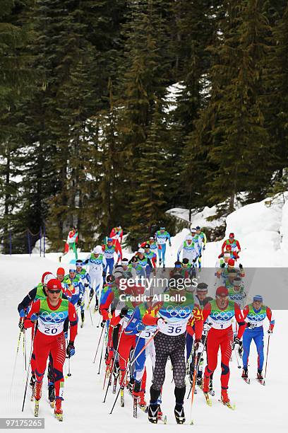 George Grey of Canada competes with Martin Johnsrud Sundby of Norway during the Men's 50 km Mass Start Classic cross-country skiing on day 17 of the...