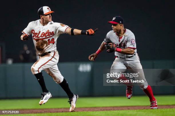Craig Gentry of the Baltimore Orioles is tagged out by Wilmer Difo of the Washington Nationals during the ninth inning at Oriole Park at Camden Yards...