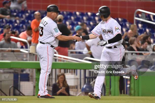 Brian Anderson of the Miami Marlins is congratulated by Third Base Coach Fredi Gonzalez after hitting a home run in the fourth inning against the San...