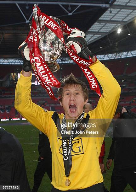 Tomasz Kuszczak of Manchester United poses with the Carling Cup trophy after the Carling Cup Final match between Aston Villa and Manchester United at...