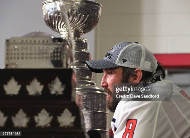 Alex Ovechkin of the Washington Capitals speaks to the media next to the Conn Smythe Trophy and the Stanley Cup after the Capitals defeated the Vegas...