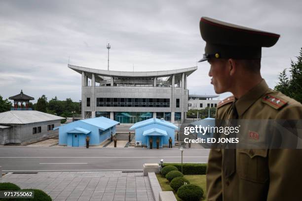 Korean People's Army soldier Lieutenant Colonel Hwang Myong Jin stands before the South Korean side of the truce village of Panmunjom on the North...