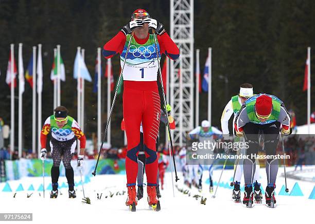 Petter Northug of Norway celebrates winning the gold medal from Axel Teichmann of Germany during the Men's 50 km Mass Start Classic cross-country...