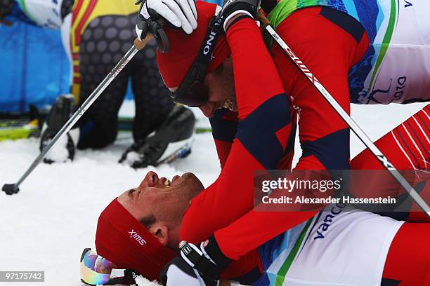 Petter Northug of Norway celebrates after winning the gold medal with Odd-Bjoern Hjelmeset of Norway during the Men's 50 km Mass Start Classic...