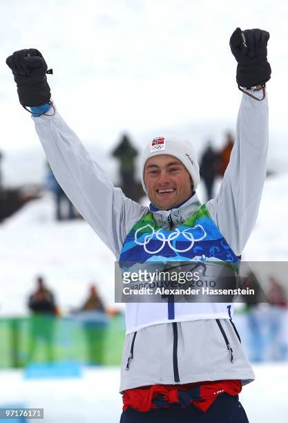Petter Northug of Norway celebrates winning the gold medal during the Men's 50 km Mass Start Classic cross-country skiing on day 17 of the 2010...