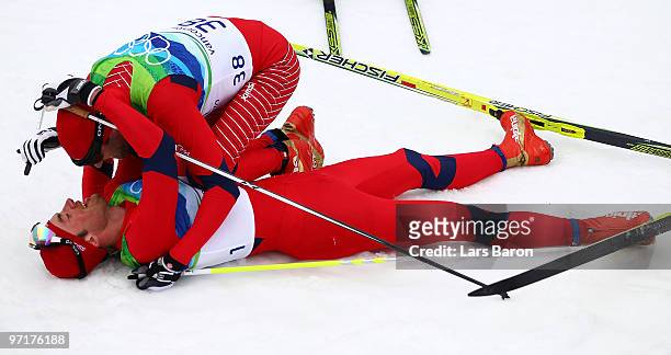 Petter Northug of Norway celebrates after winning the gold medal with Odd-Bjoern Hjelmeset of Norway during the Men's 50 km Mass Start Classic...