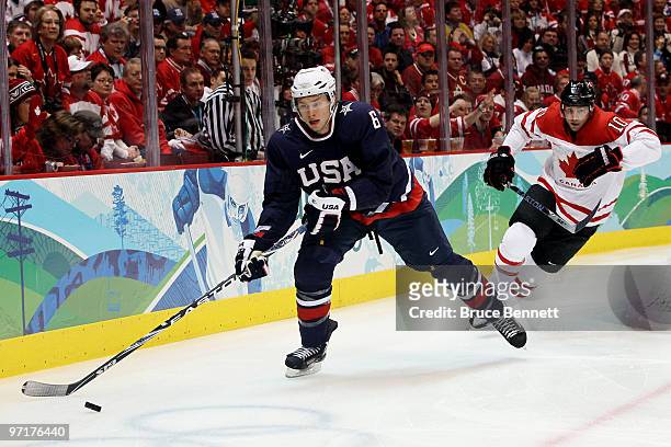 Erik Johnson of the United States is pursued by Brenden Morrow of Canada during the ice hockey men's gold medal game between USA and Canada on day 17...