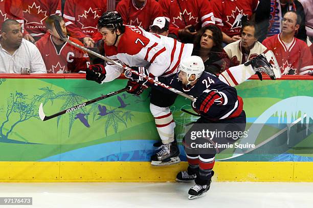 Brent Seabrook of Canada is checked by Ryan Callahan of the United States during the ice hockey men's gold medal game between USA and Canada on day...