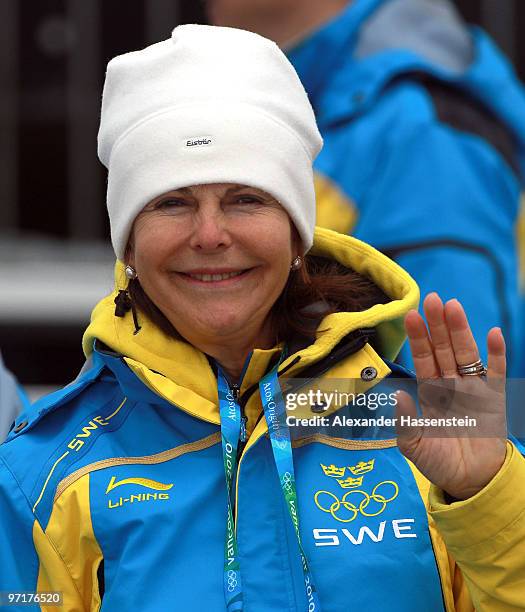 Queen Silvia of Sweden waves during the Men's 50 km Mass Start Classic cross-country skiing on day 17 of the 2010 Vancouver Winter Olympics at...