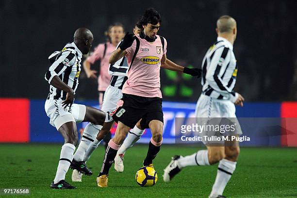 Javier Pastore of Palermo holds off the challenge from Mohammed Sissoko during the Serie A match between Juventus and Palermo at Stadio Olimpico di...
