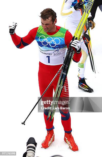 Petter Northug of Norway celebrates winning the gold medal after the Men's 50 km Mass Start Classic cross-country skiing on day 17 of the 2010...