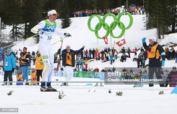 Bronze medalist Johan Olsson of Sweden celebrates during the Men's 50 km Mass Start Classic cross-country skiing on day 17 of the 2010 Vancouver...