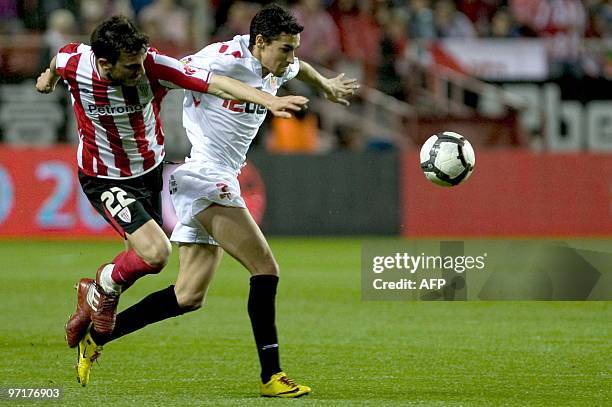 Sevilla's midfielder Jesus Navas vies for the ball with Athletic Bilbao's defender Xabier Castillo during a Spanish league football match at Sanchez...