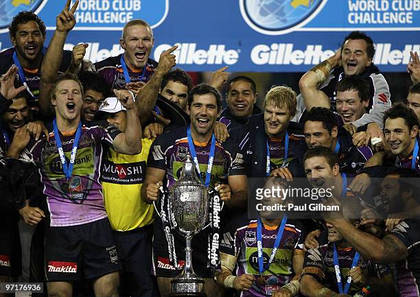 Cameron Smith of Melbourne Storm and his team-mates celebrate with the winners trophy after winning the World Club Challenge match between Leeds...