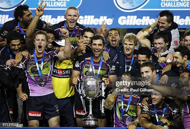 Cameron Smith of Melbourne Storm and his team-mates celebrate with the winners trophy after winning the World Club Challenge match between Leeds...