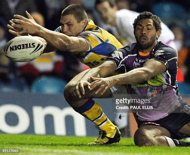 Melbourne Storm centre Michael Auld is denied a scoring opportunity by Leeds Rhinos winger Ryan Hall during the Rugby League World Club Challenge at...