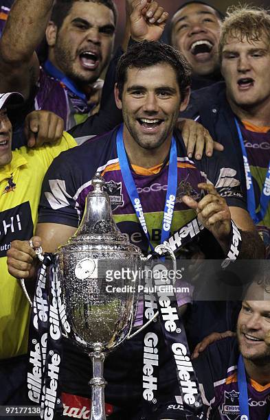 Cameron Smith of Melbourne Storm celebrates with the winners trophy after winning the World Club Challenge match between Leeds Rhinos and Melbourne...