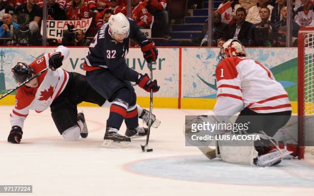 Dustin Brown of the US skates with the puck as Canada's Drew Doughty and goal keeper Roberto Luongo defend during the men's gold medal Ice Hockey...
