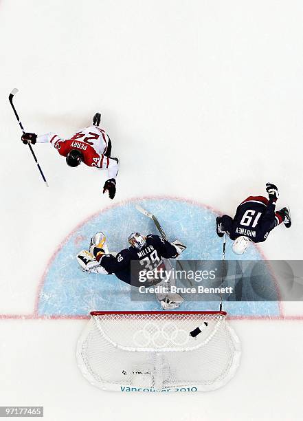 Corey Perry of Canada scores a goal past Ryan Miller of the United States in the second period during the ice hockey men's gold medal game between...