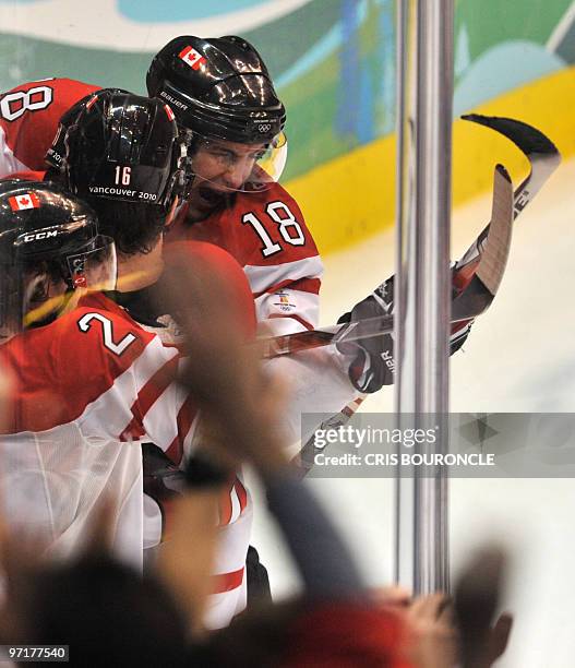 Canadian forward Michael Richards and defence Duncan Keith celebrate a goal during the Men's Gold Medal Hockey match between USA and Canada at the...