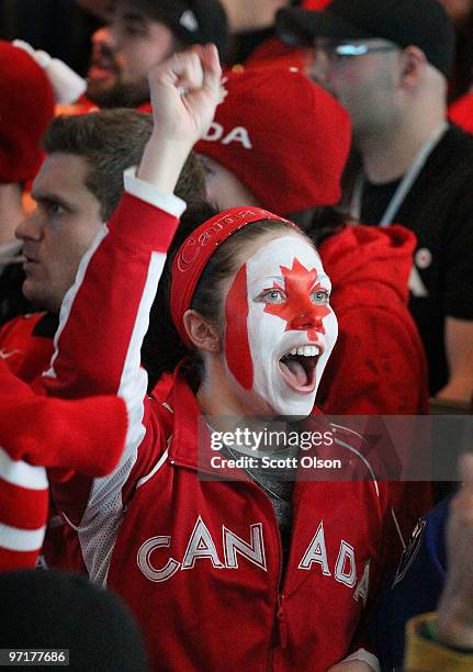 Fan celebrates as she watches the Canadian hockey team in a matchup against the USA during the ice hockey men's gold medal game on day 17 of the...