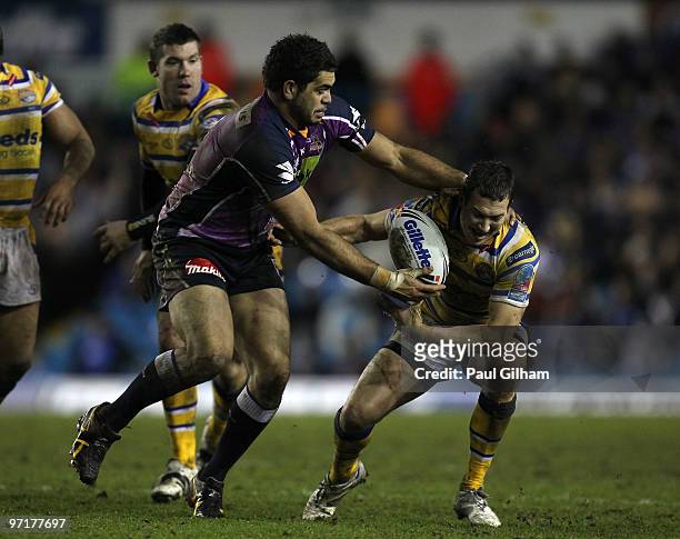Adam Blair of Melbourne Storm battles for the ball with Danny McGuire of Leeds Rhinos during the World Club Challenge match between Leeds Rhinos and...