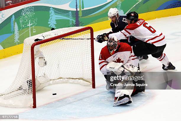 Ryan Kesler of the United States scores a goal on the deflection past Roberto Luongo and Shea Weber of Canada during the ice hockey men's gold medal...