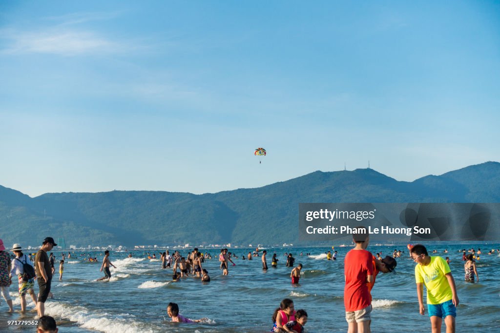 Real People enjoying their happy summer day on My Khe beach of Da nang, Vietnam