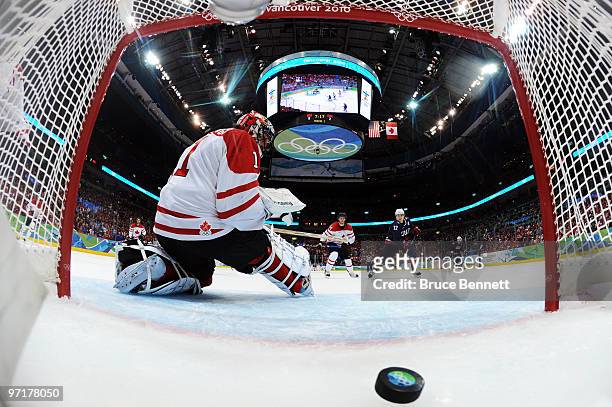 Goalkeeper Roberto Luongo of Canada gives up a goal to Ryan Kesler scores his team's opening goal during the ice hockey men's gold medal game between...