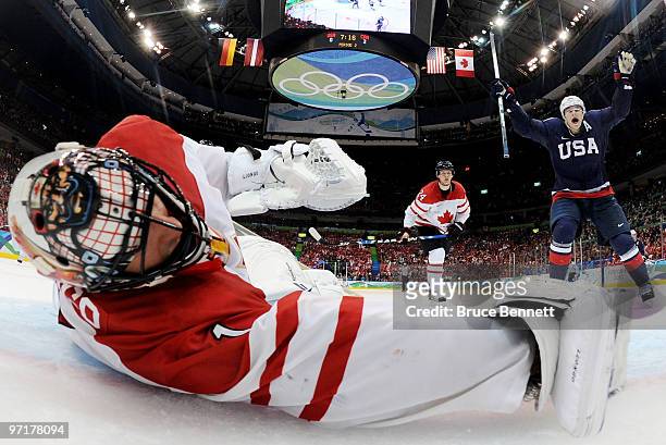 Goalkeeper Roberto Luongo of Canada dives in vain as Ryan Kesler scores his team's opening goal during the ice hockey men's gold medal game between...