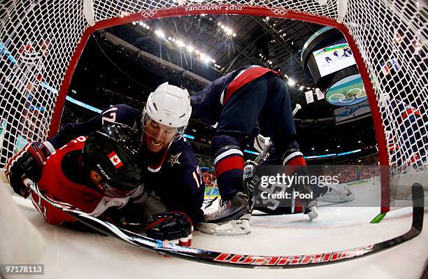 Patrick Marleau of Canada and Ryan Malone of the United States collide in the goalmouth during the ice hockey men's gold medal game between USA and...