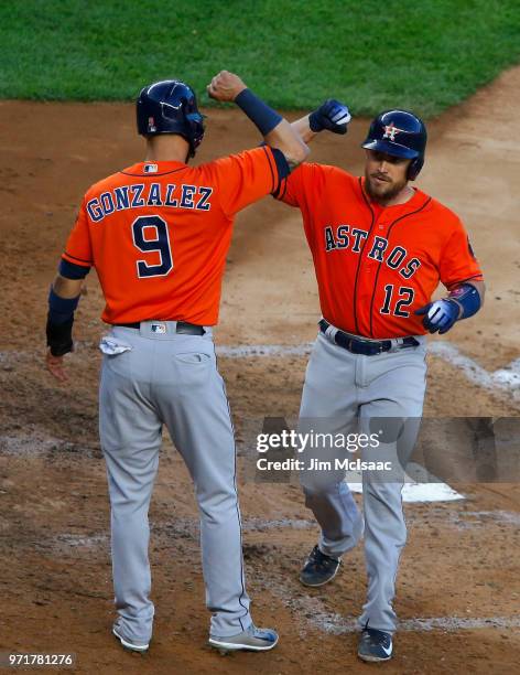 Max Stassi of the Houston Astros celebrates his two run home run against the New York Yankees with teammate Marwin Gonzalez at Yankee Stadium on May...