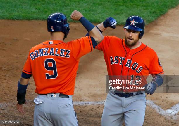 Max Stassi of the Houston Astros celebrates his two run home run against the New York Yankees with teammate Marwin Gonzalez at Yankee Stadium on May...