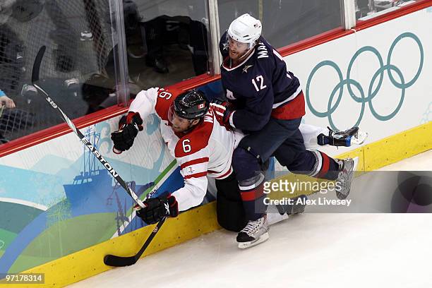 Shea Weber of Canada is checked by Ryan Malone of the United States during the ice hockey men's gold medal game between USA and Canada on day 17 of...