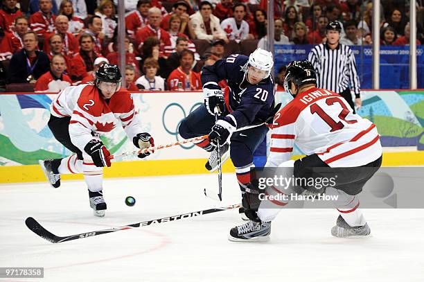 Ryan Suter of the United States passes the puck as Duncan Keith and Jarome Iginla of Canada close in during the ice hockey men's gold medal game...