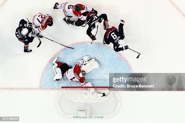 Zach Parise of the United States shoots the puck past Roberto Luongo of Canada late in third period during the ice hockey men's gold medal game...