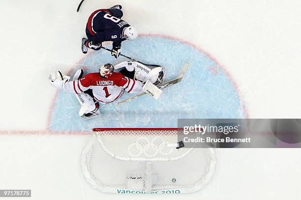 Zach Parise of the United States shoots the puck past Roberto Luongo of Canada late in third period during the ice hockey men's gold medal game...