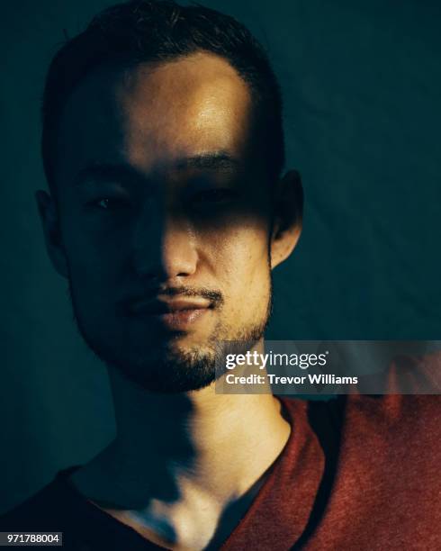 portrait of a mid adult man with shadow over his eyes - mental toughness stock pictures, royalty-free photos & images